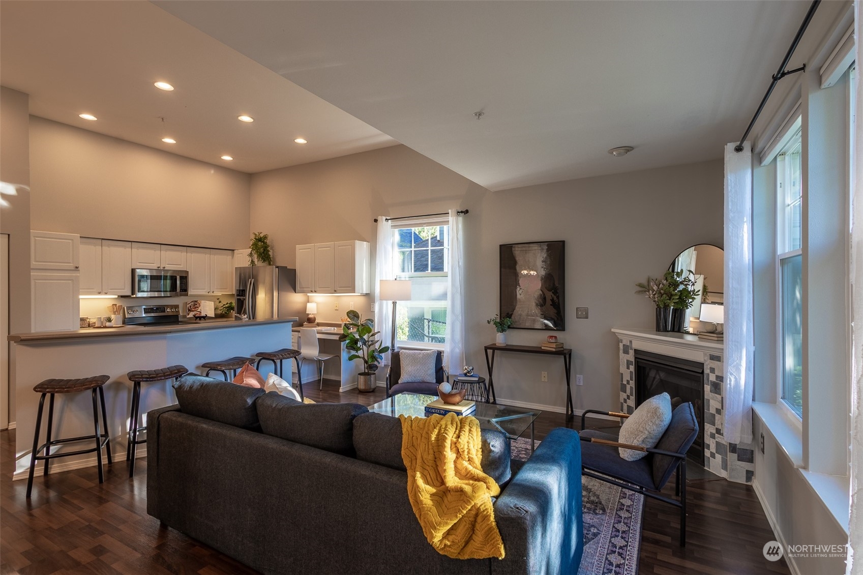 16125 Juanita Woodinville Way Northeast, Unit 2201 Bothell, WA 98011 - Photo 2 of 35 a living room with furniture and a flat screen tv