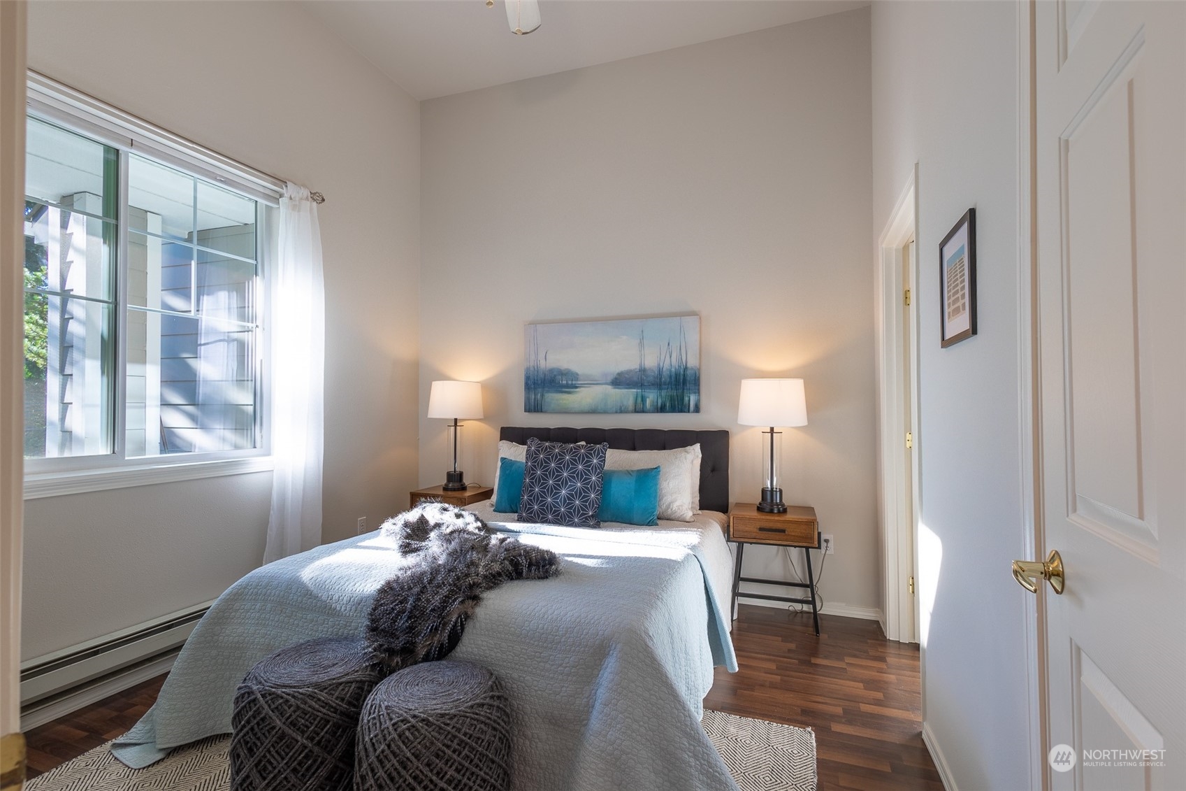 16125 Juanita Woodinville Way Northeast, Unit 2201 Bothell, WA 98011 - Photo 22 of 35 a bedroom with a bed and wooden floor