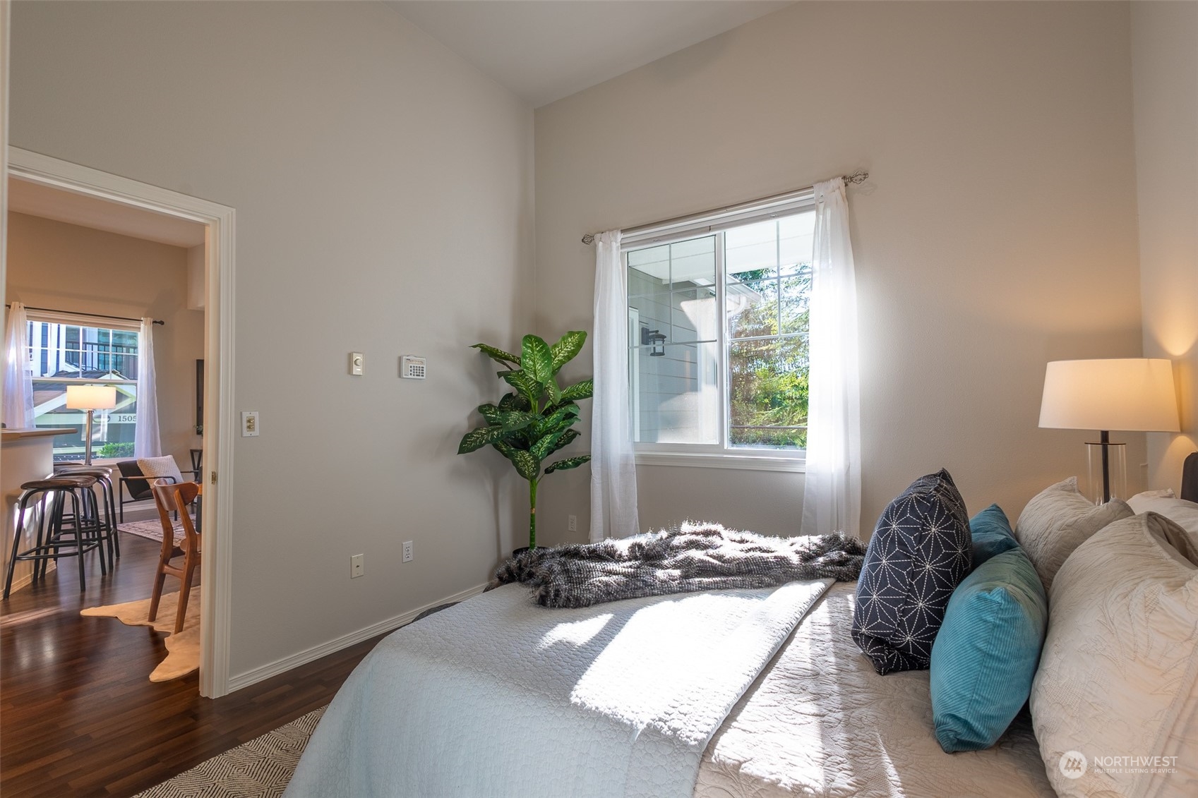 16125 Juanita Woodinville Way Northeast, Unit 2201 Bothell, WA 98011 - Photo 24 of 35 a bedroom with a bed and a potted plant