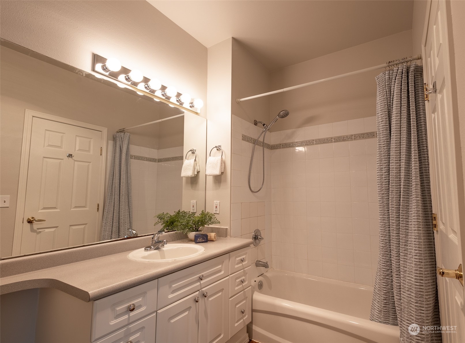16125 Juanita Woodinville Way Northeast, Unit 2201 Bothell, WA 98011 - Photo 29 of 35 a bathroom with a sink tub vanity and a mirror