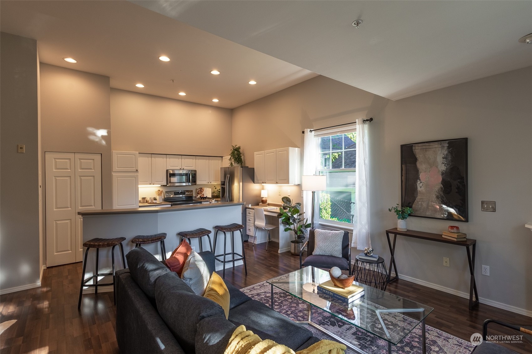 16125 Juanita Woodinville Way Northeast, Unit 2201 Bothell, WA 98011 - Photo 3 of 35 a living room with furniture a flat screen tv and kitchen view