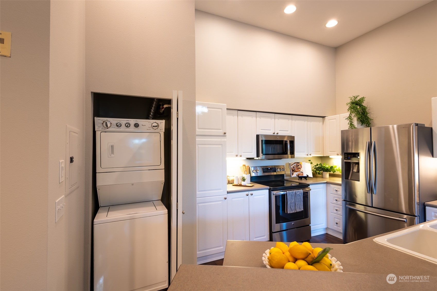 16125 Juanita Woodinville Way Northeast, Unit 2201 Bothell, WA 98011 - Photo 8 of 35 a kitchen with stainless steel appliances granite countertop a refrigerator a stove and a sink