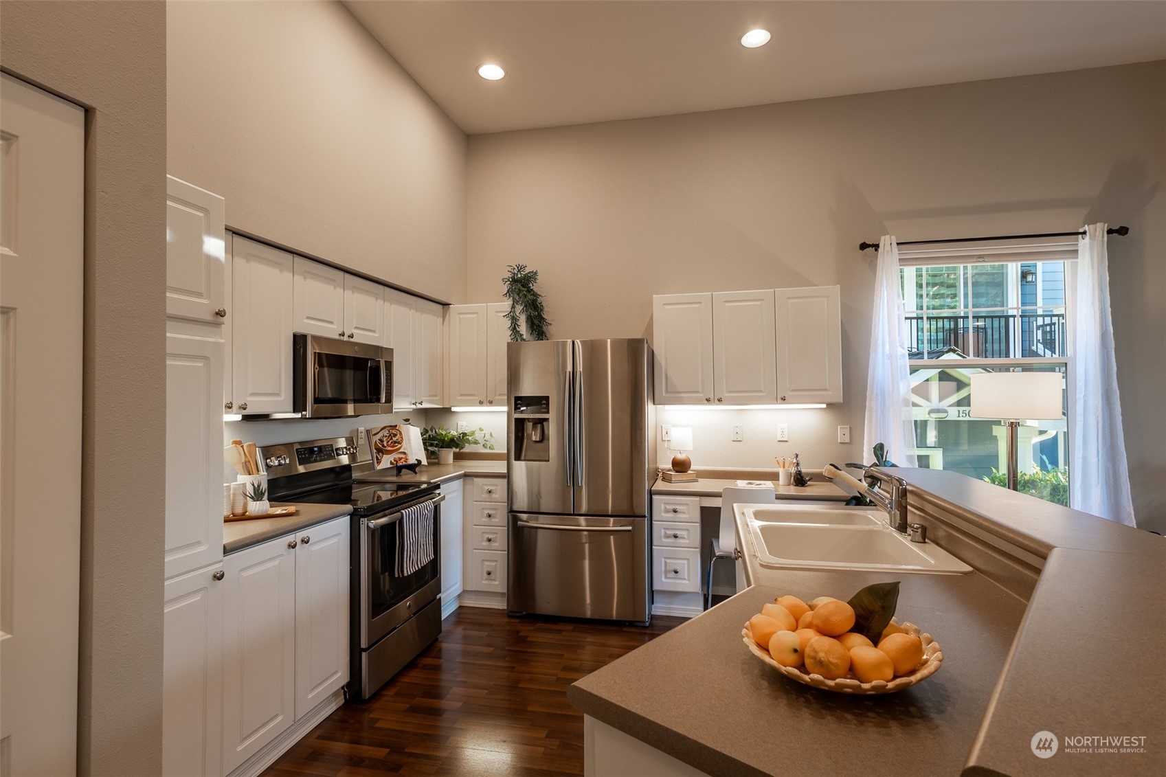 16125 Juanita Woodinville Way Northeast, Unit 2201 Bothell, WA 98011 - Photo 10 of 35 a kitchen with stainless steel appliances granite countertop a sink a stove and a refrigerator