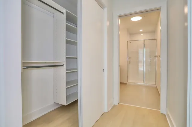 a bathroom with a double vanity sink toilet and shower