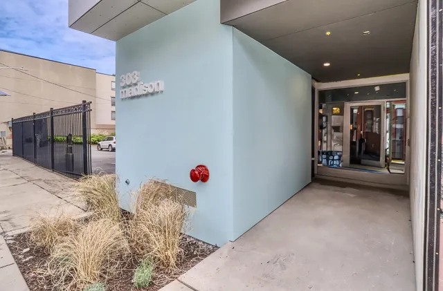 a front view of a building with car parked