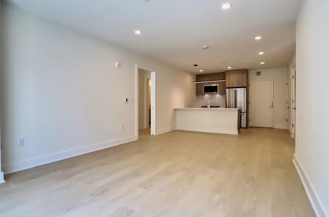 a view of a livingroom with a kitchen