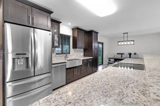 a kitchen with kitchen island cabinets and refrigerator