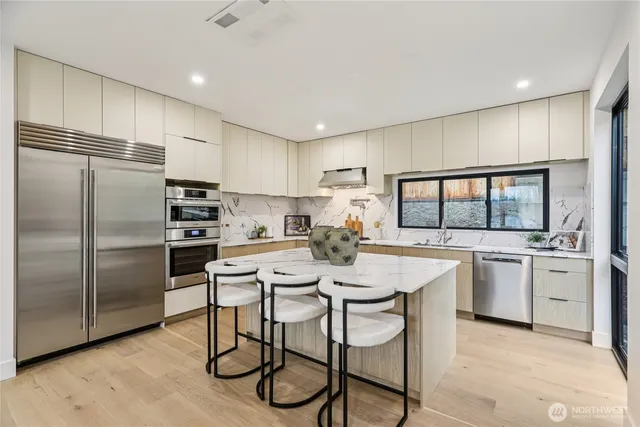 a kitchen with kitchen island a large counter top space appliances and cabinets