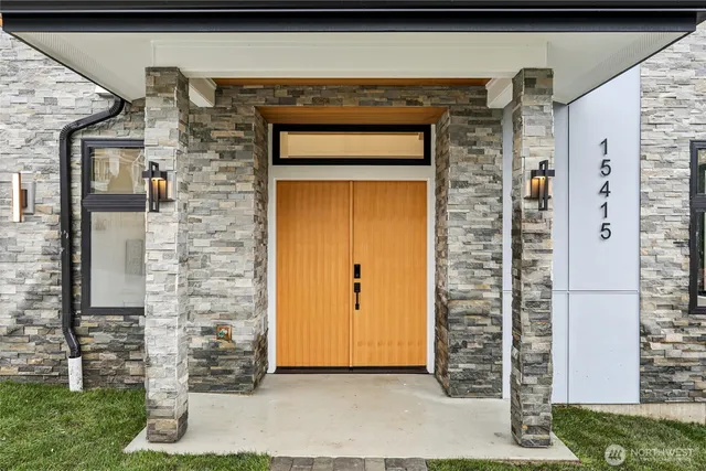 a front view of a house with a garden