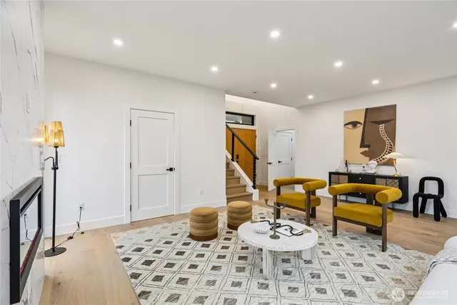 a living room with furniture and wooden floor