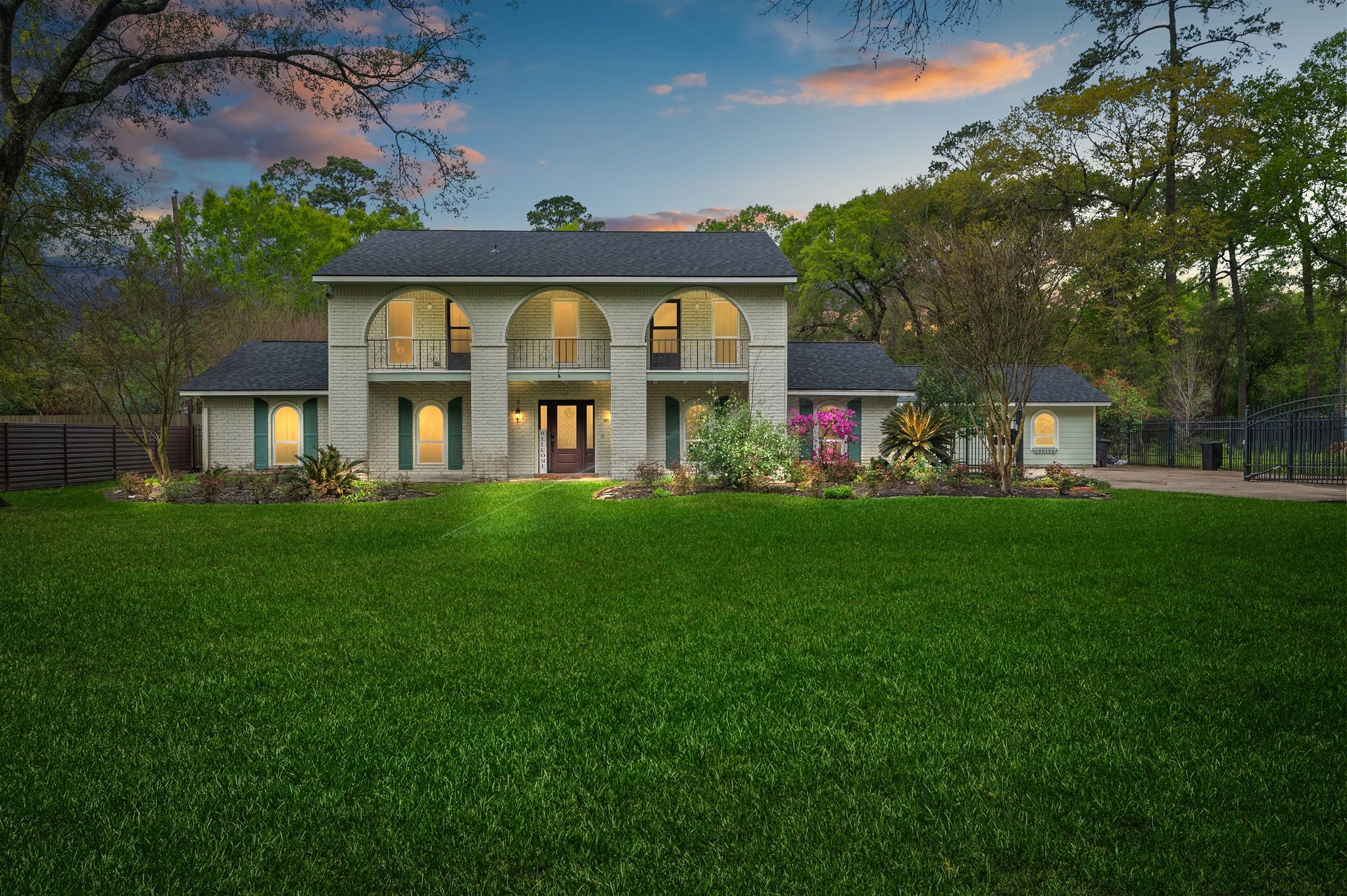 a front view of a house with a garden