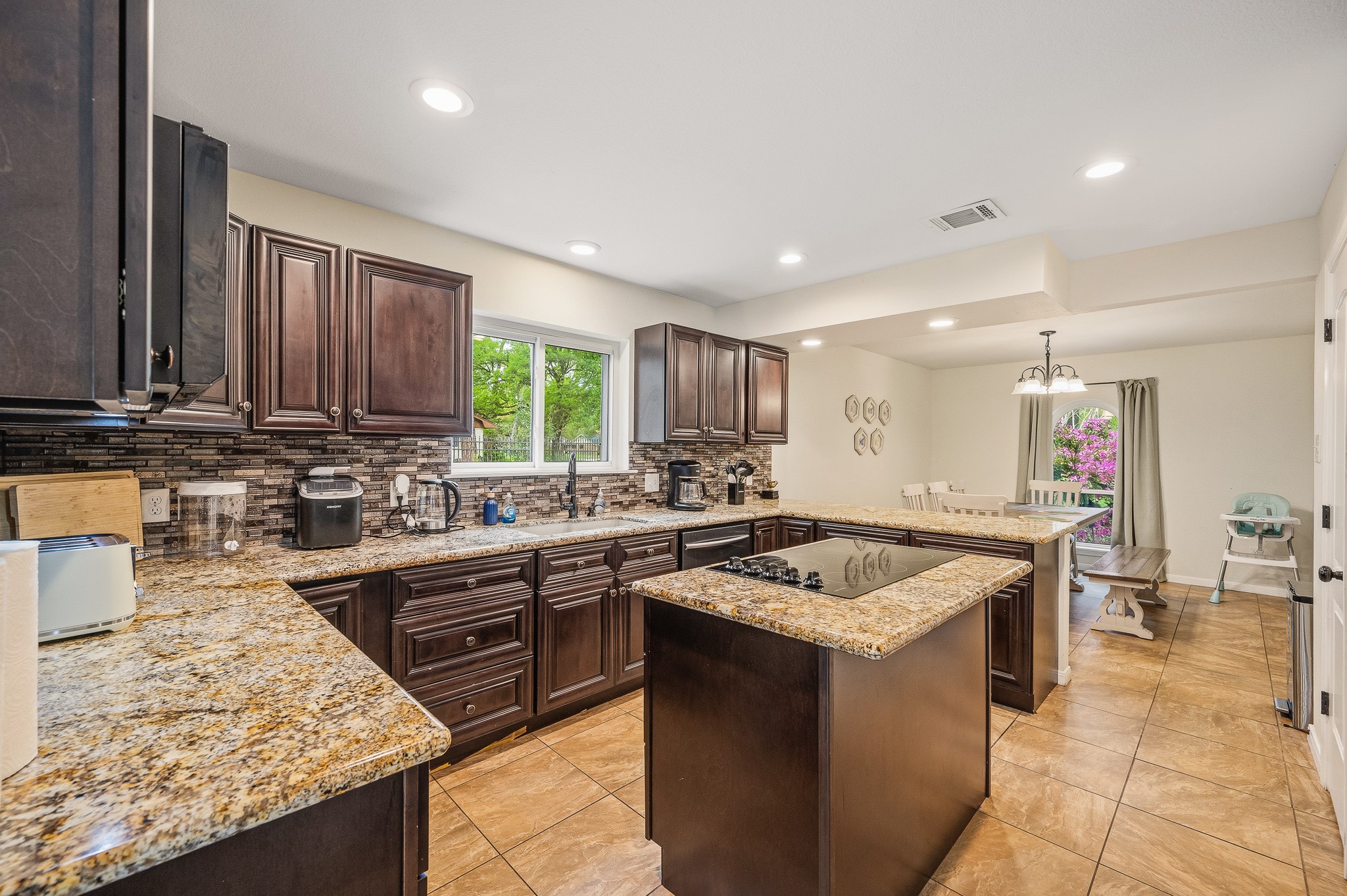 16811 Waycreek Road Houston, TX 77068 - Photo 24 of 50 a kitchen with a stove sink and cabinets