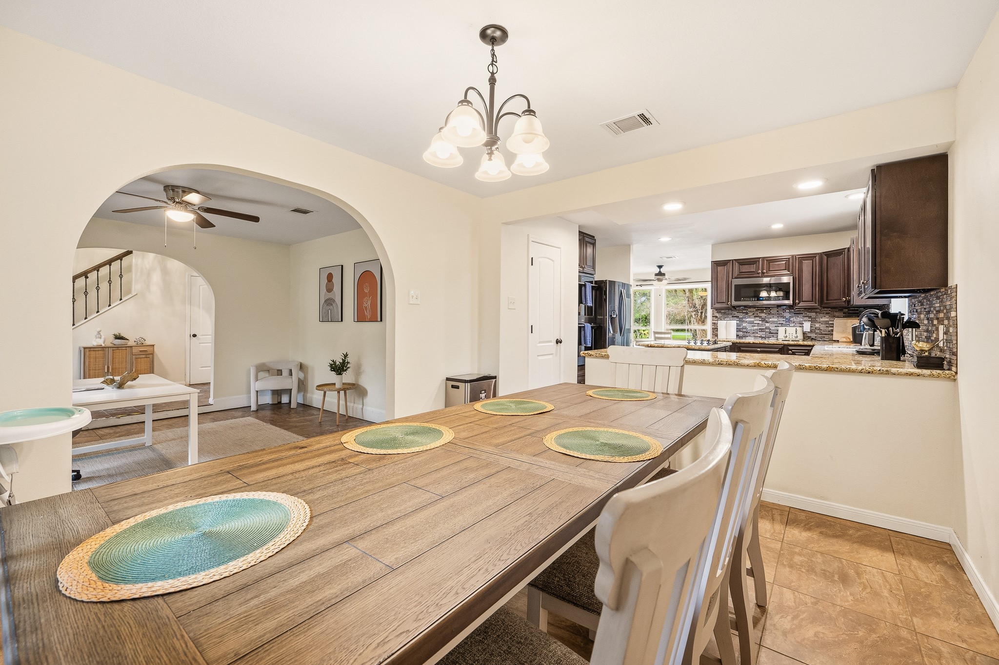 16811 Waycreek Road Houston, TX 77068 - Photo 27 of 50 a dining room with kitchen island granite countertop a sink a center island stainless steel appliances and cabinets