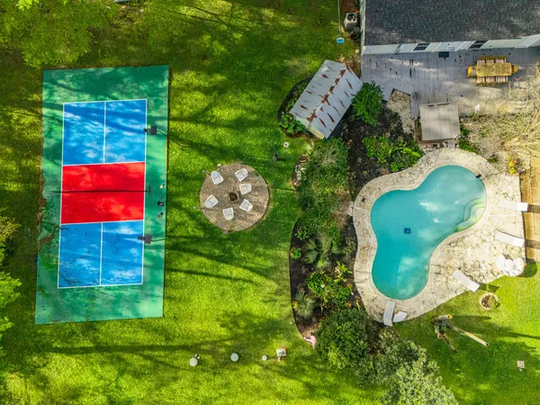 a dining room with kitchen island granite countertop a sink a center island stainless steel appliances and cabinets