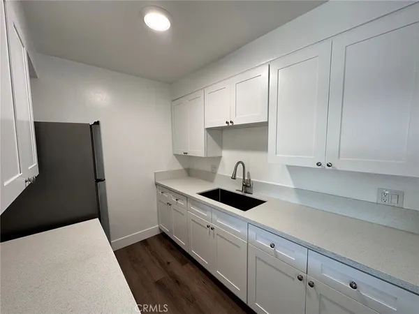 a kitchen with stainless steel appliances a sink stove and refrigerator