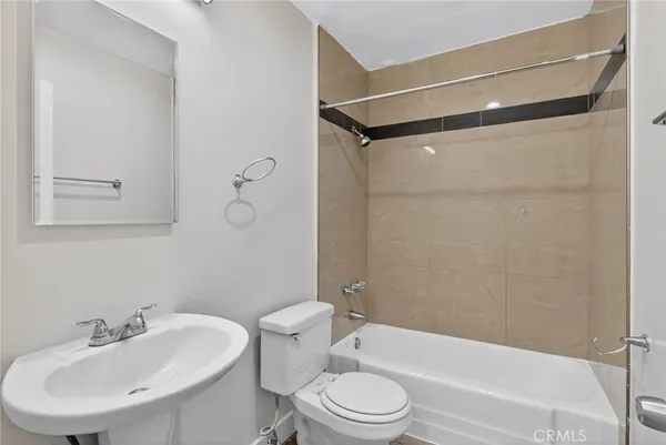 a bathroom with a toilet a sink and bathtub