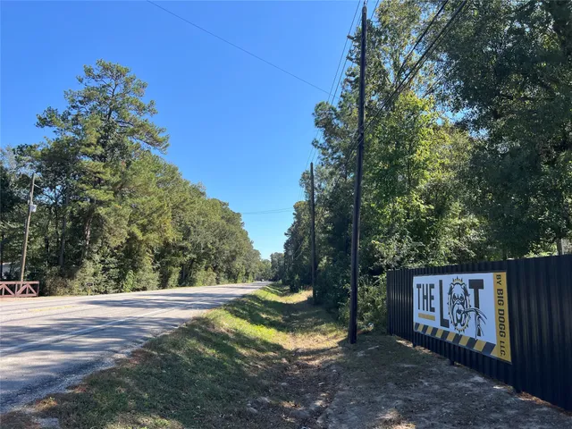 a view of a street with a bench in the background