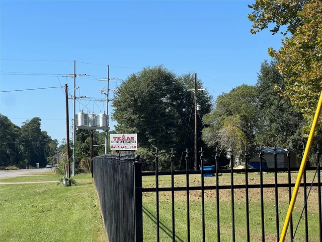 a view of a park with iron fence