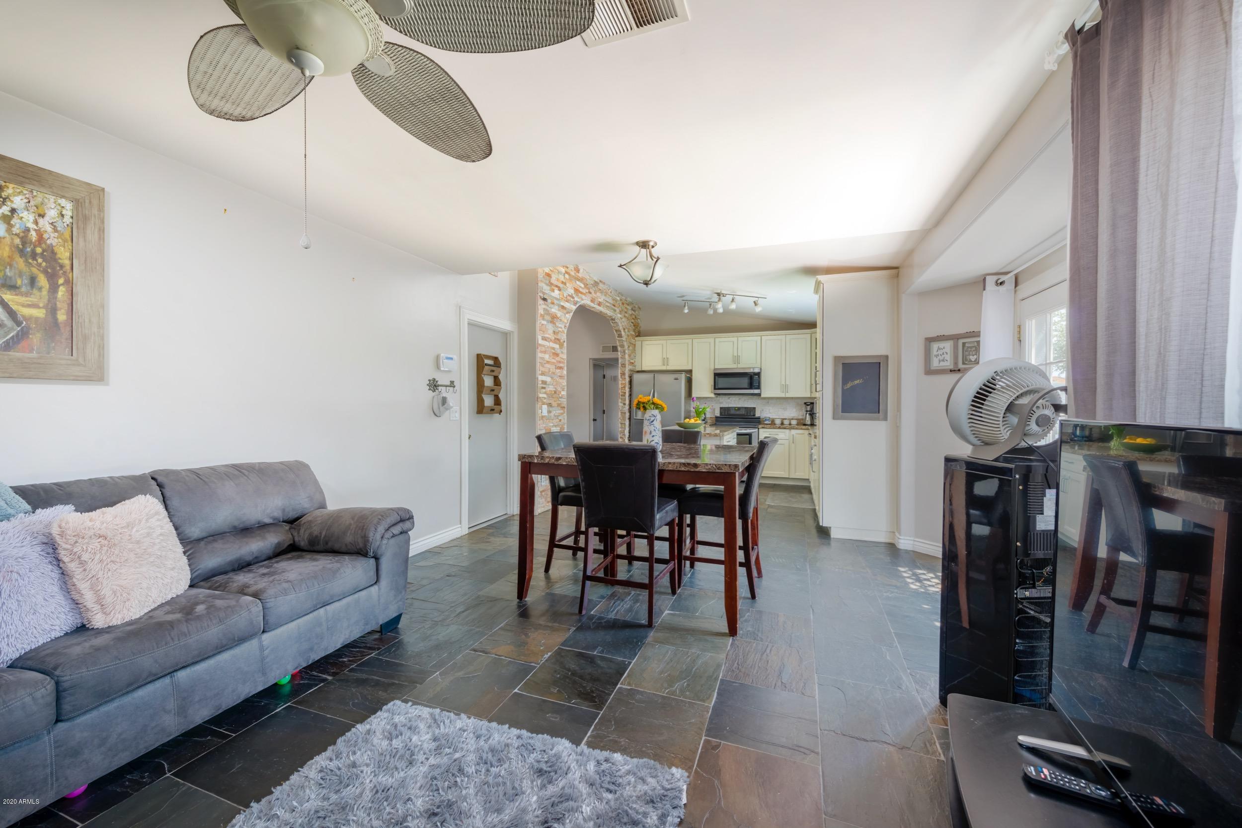 1407 East Fremont Road Phoenix, AZ 85042 - Photo 3 of 27 a living room with furniture kitchen view and a chandelier