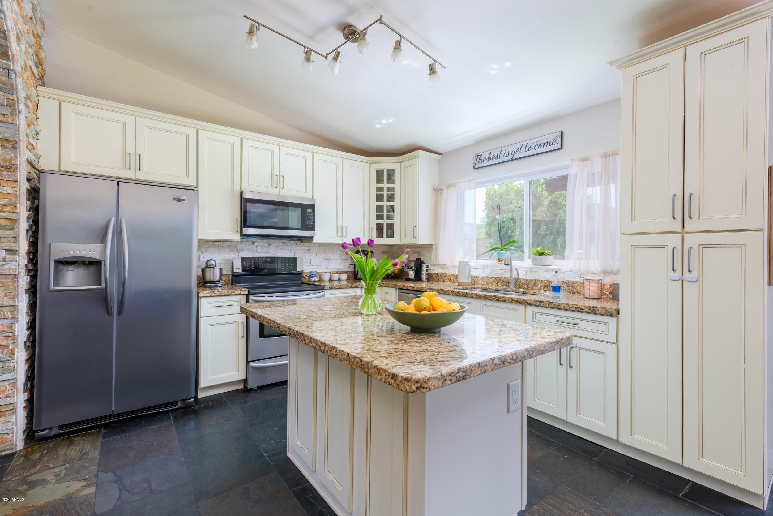 1407 East Fremont Road Phoenix, AZ 85042 - Photo 5 of 27 a kitchen with stainless steel appliances granite countertop a sink stove and refrigerator