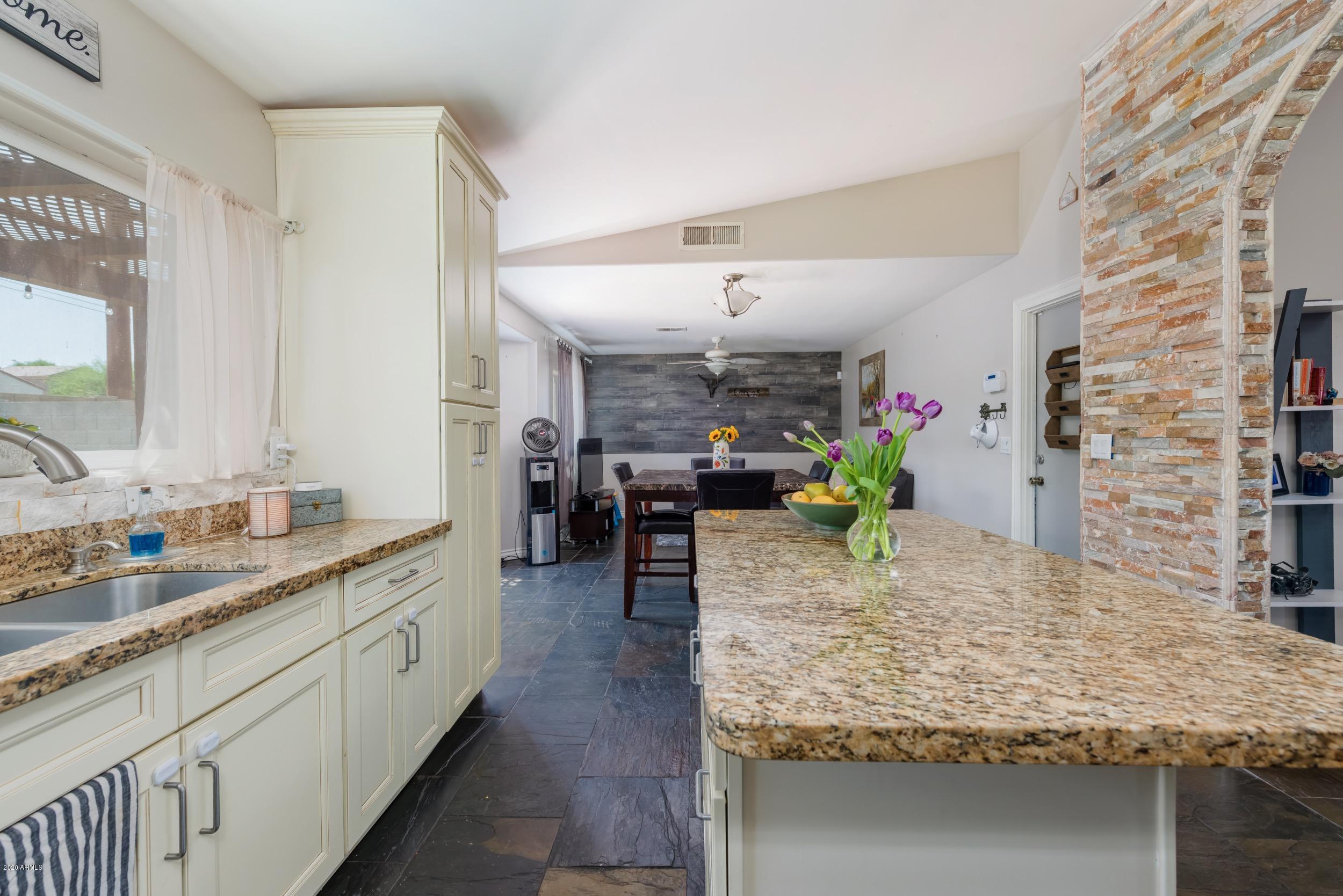 1407 East Fremont Road Phoenix, AZ 85042 - Photo 6 of 27 a large kitchen with kitchen island sink stove and cabinets