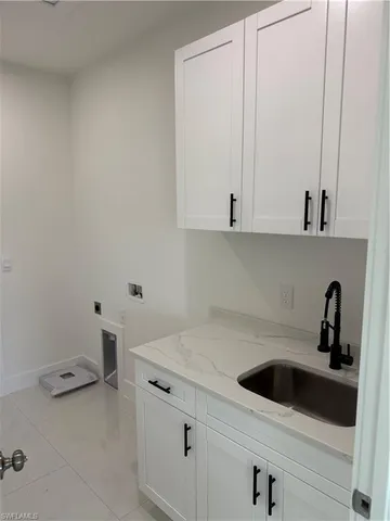 a view of a kitchen with white cabinets