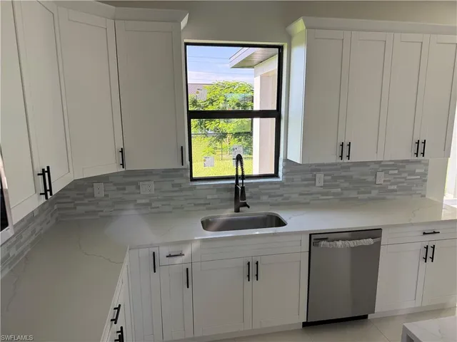 a kitchen with a sink and large window