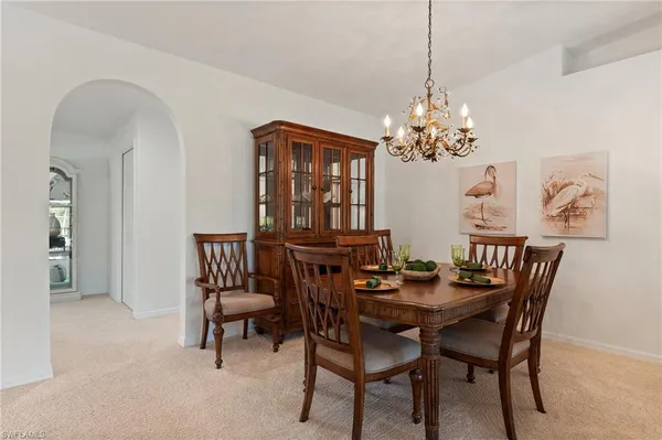 a view of a dining room with furniture and chandelier