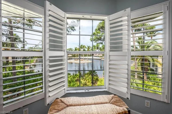 a lake view with boat and palm trees