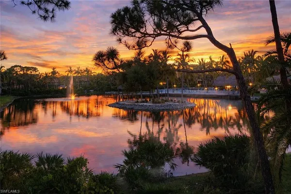 a bed sitting in a spacious bedroom next to a window