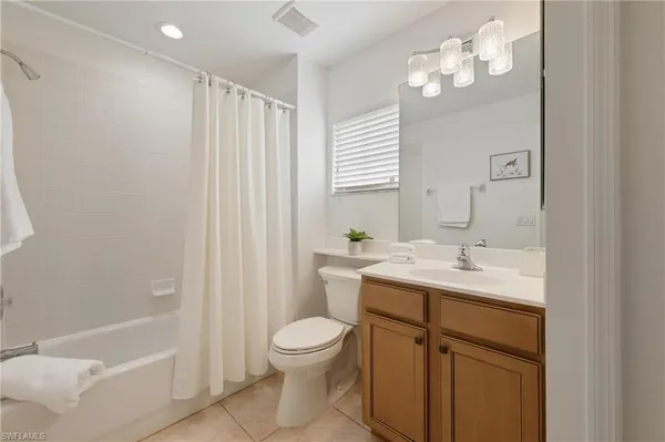 a large bathroom with a large mirror vanity and sink