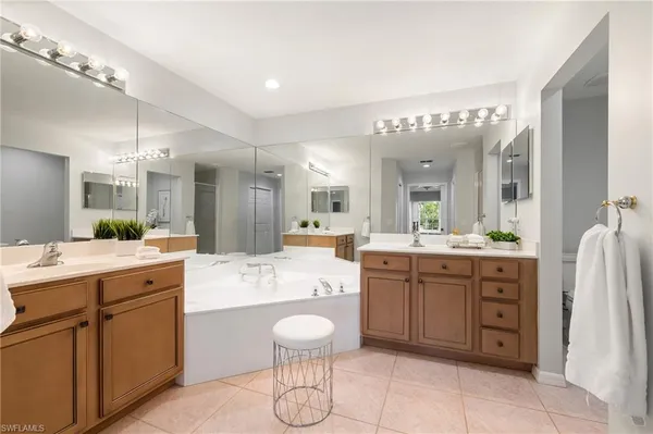 a large bathroom with a double vanity sink a mirror and a shower