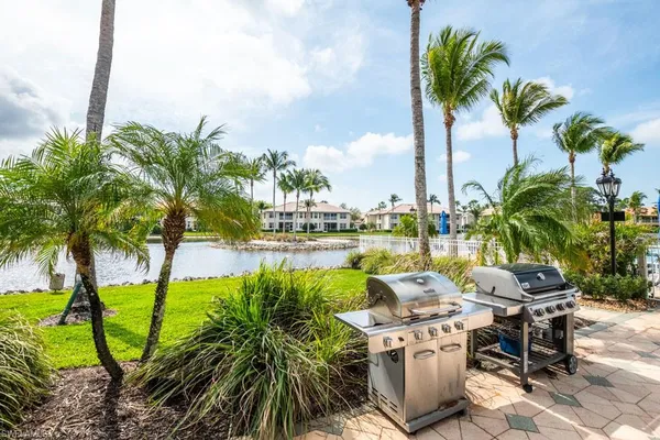 a row of palm trees and swimming pool in the garden