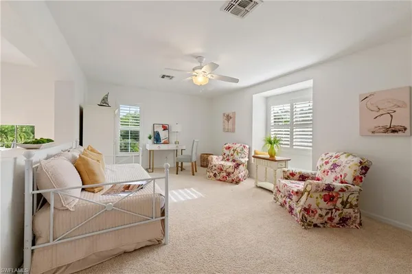 a bed room with furniture and a chandelier