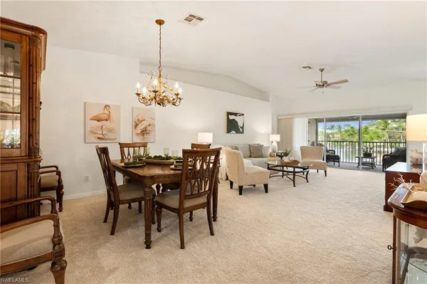 a view of a dining room with furniture and a chandelier