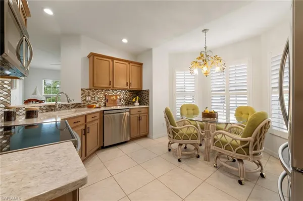 a dining room with furniture and chandelier