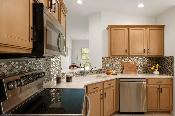 a kitchen with a sink stove and cabinets