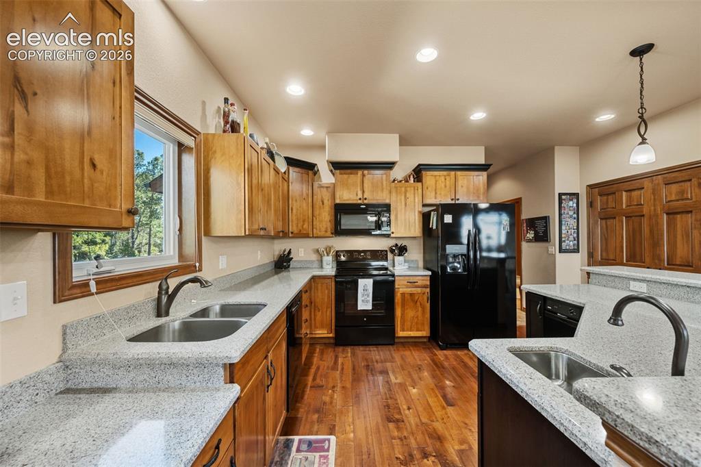 131 Paradiso Road Divide, CO 80814 - Photo 19 of 50 a kitchen with granite countertop a refrigerator and a sink