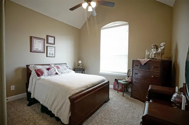 a living room with pool table and a ceiling fan