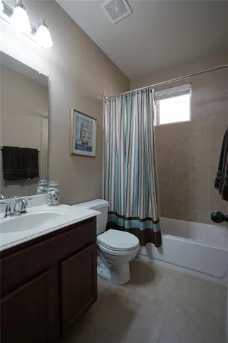 a living room with furniture and a lamp