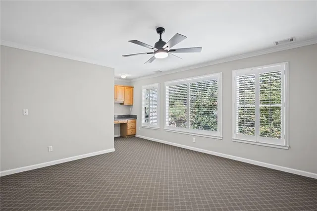 an aerial view of a house with a yard and lake view