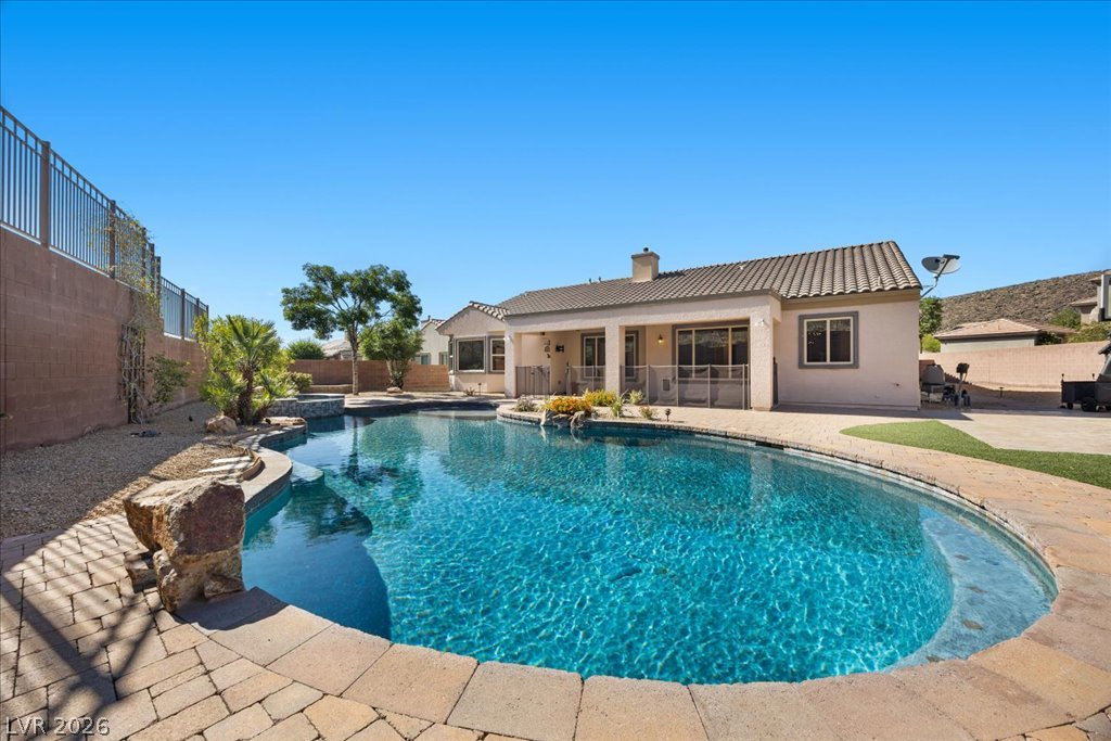2125 De Rouge Avenue Henderson, NV 89044 - Photo 79 of 96 A private outdoor oasis awaits with a sparkling pool and spa, perfect for relaxation and entertainment.