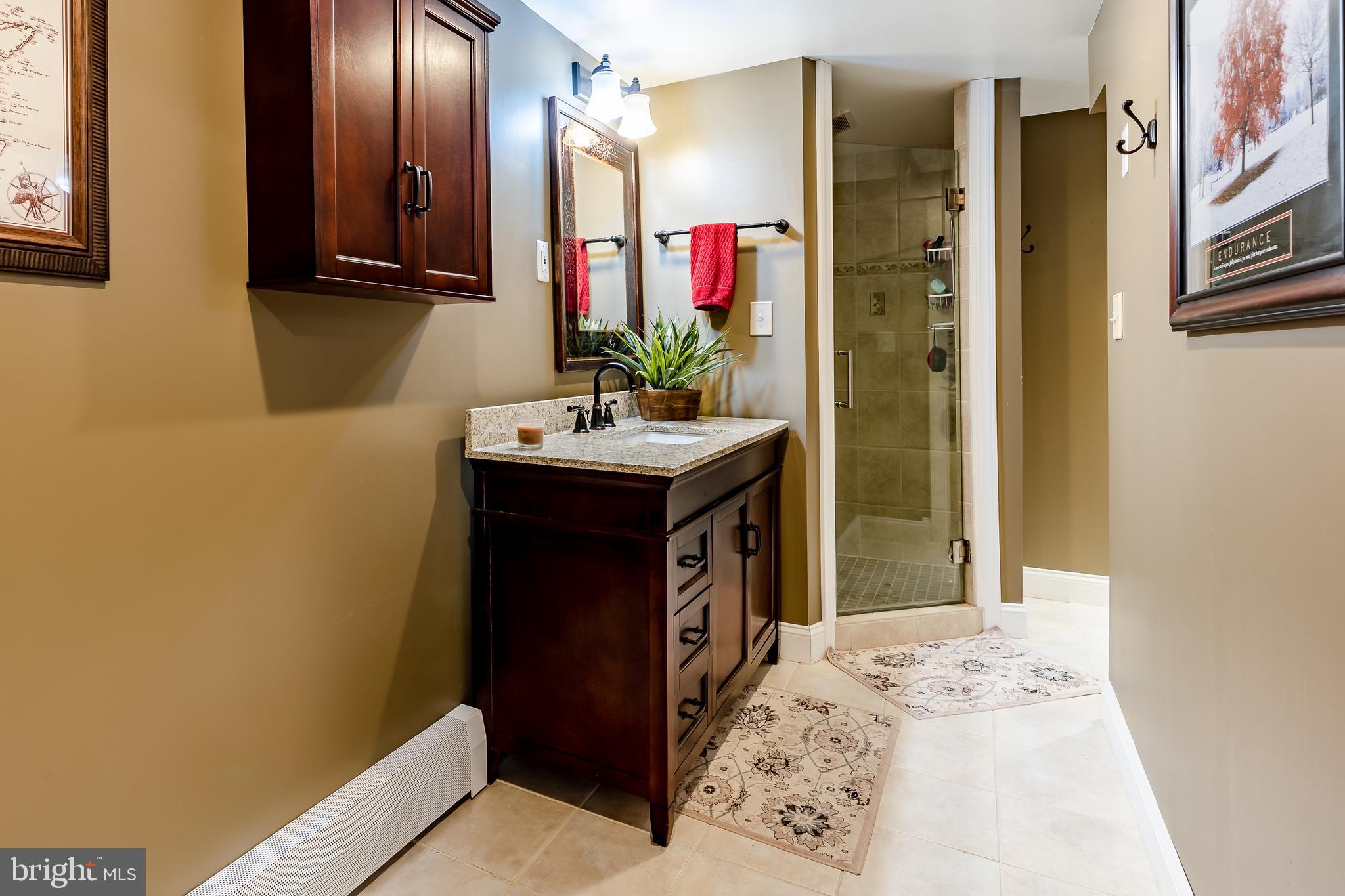 411 Linville Road Media, PA 19063 - Photo 28 of 33 Third full bathroom with tile shoer, cherry vanity