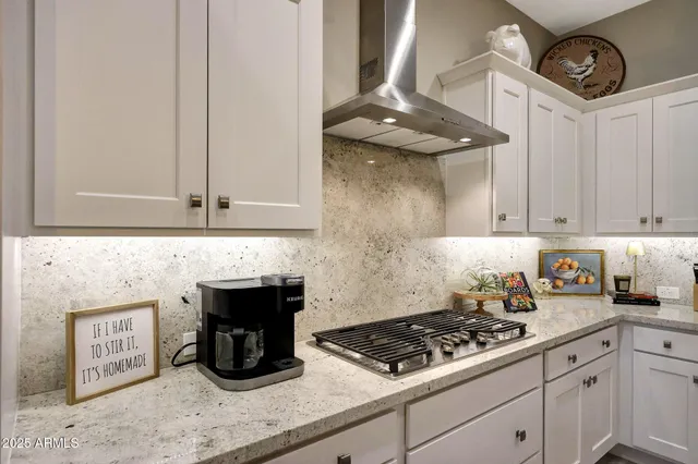 a kitchen with stainless steel appliances a stove and cabinets