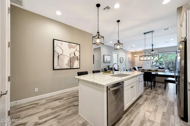a kitchen with a sink stove and wooden floor