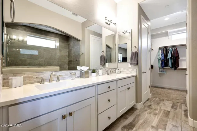 a bathroom with a double vanity sink and a mirror