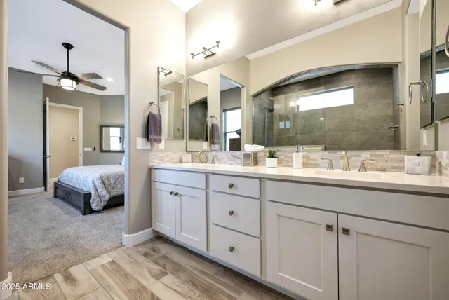 a spacious bathroom with a double vanity sink mirror and double