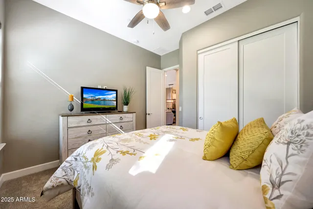 a bedroom with a bed and a flat screen tv