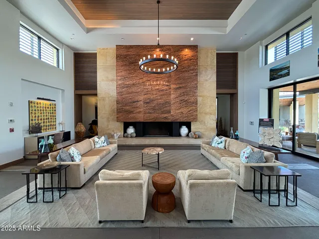 a living room with furniture wooden floor and wall painting