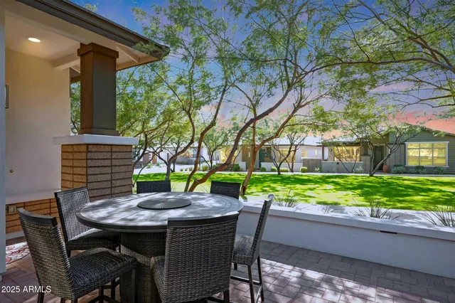 a backyard of a house with a garden and outdoor seating